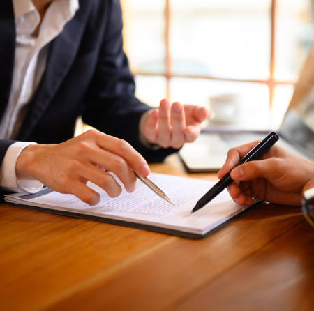 Closeup business person pointing at contract showing male client where to signature sign.