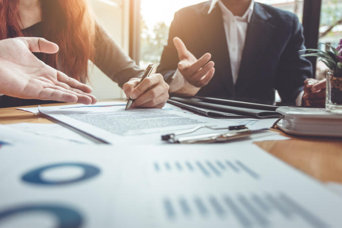 Business Signing a Contract on a table with a pen